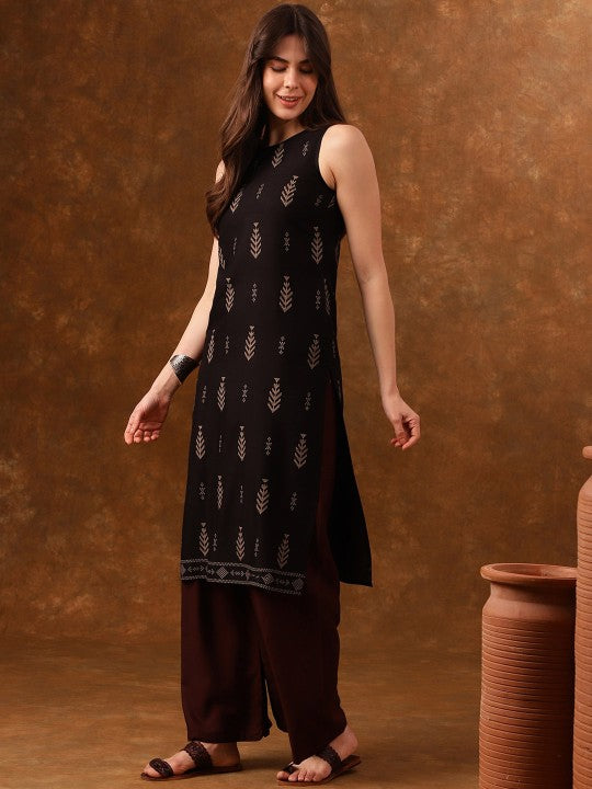 Black sleeveless patterned dress worn by a woman