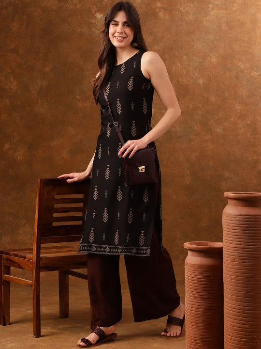 Woman in black patterned dress near chair and pots