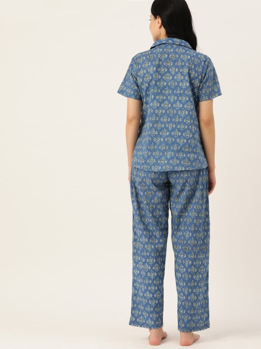 Person wearing blue patterned pajama set on white background