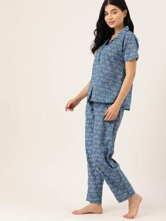 Woman wearing a blue floral pajama set on a white background