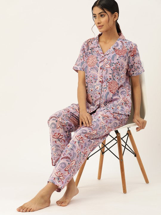 Woman wearing floral pajama set on white background