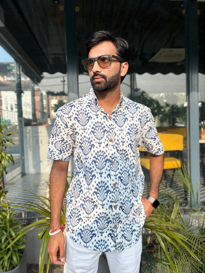 Man wearing patterned shirt and sunglasses outdoors