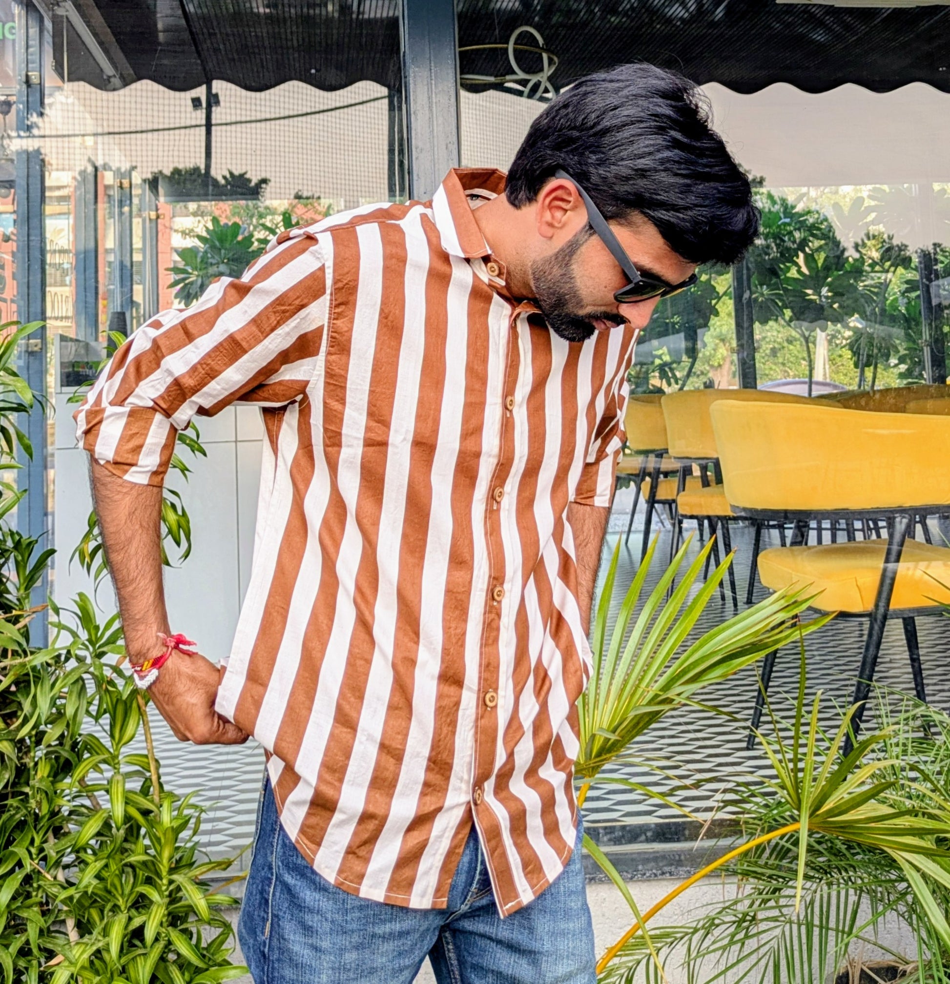 Brown white striped shirt worn by a man