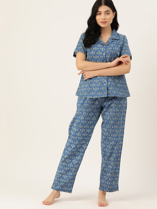 Woman wearing a blue floral pajama set on a white background